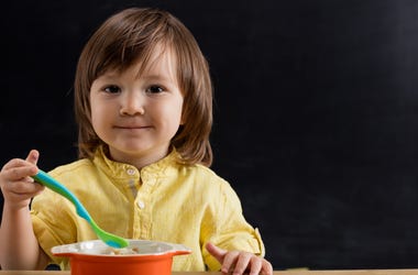 Child Eating From Bowl