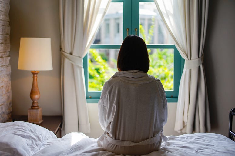 Woman Sitting On A Bed