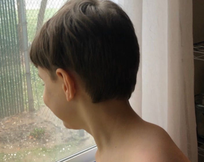 Child Looking Out Of Window At Hail. LDG