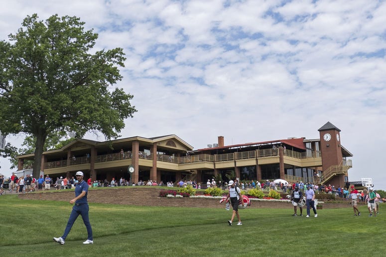 Dustin Johnson walks from the first tee box during the final round of the WGC - Bridgestone Invitational golf tournament at Firestone Country Club Dustin Johnson walks from the first tee box during the final round of the WGC - Bridgestone Invitational golf tournament at Firestone Country Club