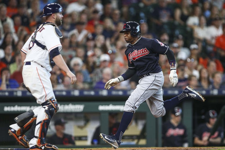 Cleveland Indians center fielder Rajai Davis (26) scores a run as Houston Astros catcher Brian McCann (16) looks on during the fifth inning at Minute Maid Park. Cleveland Indians center fielder Rajai Davis (26) scores a run as Houston Astros catcher Brian McCann (16) looks on during the fifth inning at Minute Maid Park.