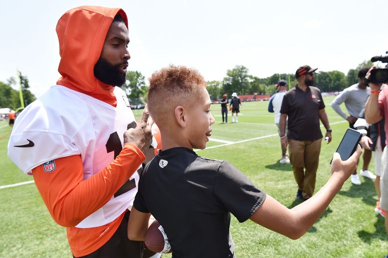 Cleveland Browns wide receiver Odell Beckham (13) poses for a photo with a fan after training camp at the Cleveland Browns Training Complex. Cleveland Browns wide receiver Odell Beckham (13) poses for a photo with a fan after training camp at the Cleveland Browns Training Complex.