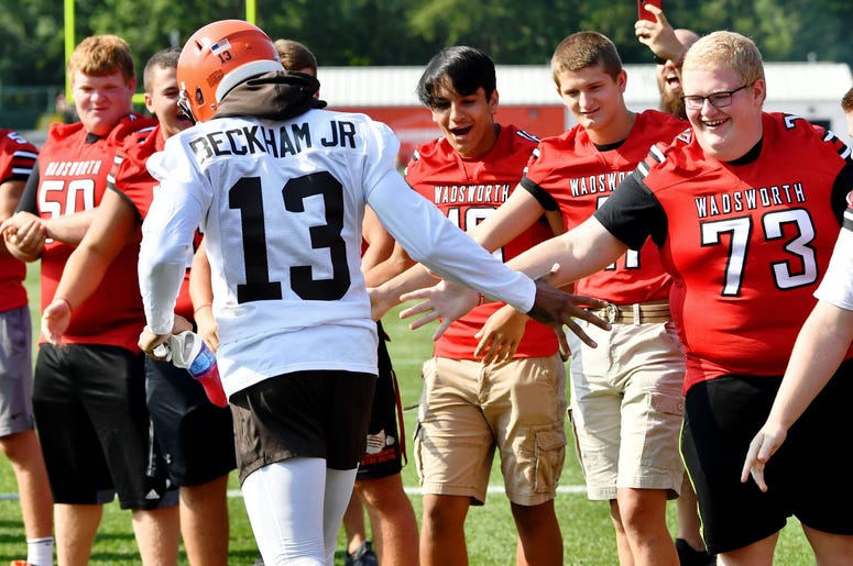 Cleveland Browns wide receiver Odell Beckham (13) slaps hands with the Wadsworth High School football team as he enters the field during training camp at the Cleveland Browns Training Complex. Cleveland Browns wide receiver Odell Beckham (13) slaps hands with the Wadsworth High School football team as he enters the field during training camp at the Cleveland Browns Training Complex.