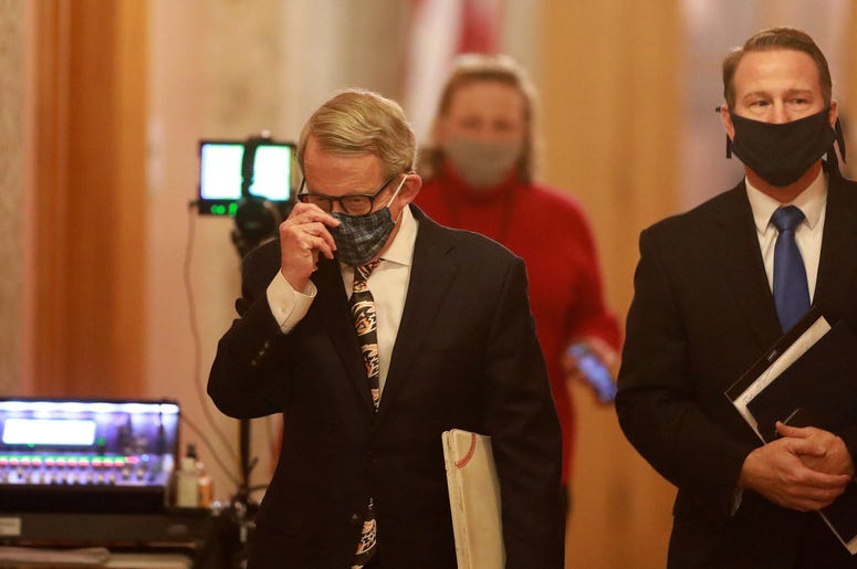 Ohio Gov. Mike DeWine (left) and Lt. Gov. Jon Husted wear their masks while walking into the daily coronavirus news conference on Friday, April 17, 2020 at the Ohio Statehouse in Columbus, Ohio. ghows-OH-200619928-11c6f288.jpg