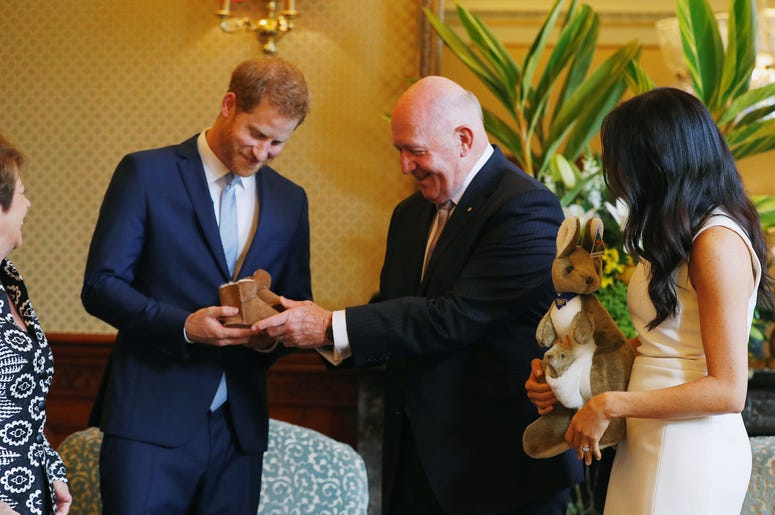 Australia's Governor General Peter Cosgrove and his wife Lynne Cosgrove give the Duke and Duchess of Sussex a toy kangaroo - with a baby - and a pair of children's boots at Admiralty House in Sydney on the first day of the royal couple's visit to Australi Australia's Governor General Peter Cosgrove and his wife Lynne Cosgrove give the Duke and Duchess of Sussex a toy kangaroo - with a baby - and a pair of children's boots at Admiralty House in Sydney on the first day of the royal couple's visit to Australi
