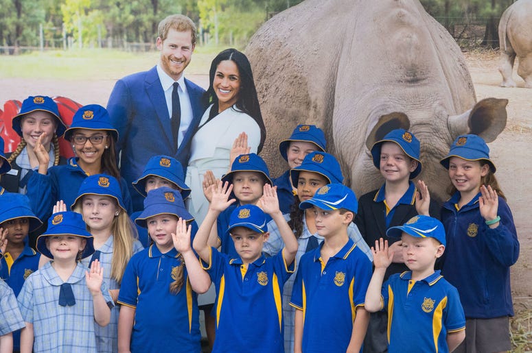 Pupils from South Dubbo Public School pose for a photo with a picture of the Duke and Duchess of Sussex as they await their arrival at Dubbo City Regional Airport, in Dubbo, New South Wales, on the second day of the royal couple's visit to Australia. Pupils from South Dubbo Public School pose for a photo with a picture of the Duke and Duchess of Sussex as they await their arrival at Dubbo City Regional Airport, in Dubbo, New South Wales, on the second day of the royal couple's visit to Australia.