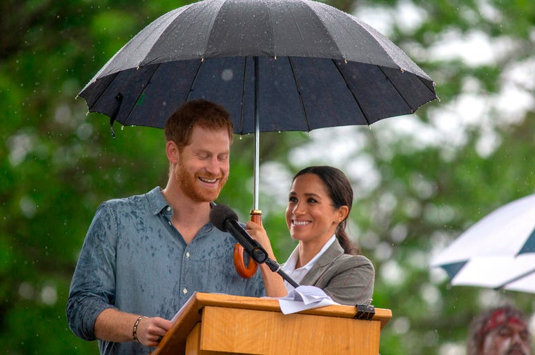 he Duchess of Sussex holds an umbrella as the Duke of Sussex makes a speech at a community picnic in Victoria Park in Dubbo, New South Wales, on the second day of the royal couple's visit to Australia he Duchess of Sussex holds an umbrella as the Duke of Sussex makes a speech at a community picnic in Victoria Park in Dubbo, New South Wales, on the second day of the royal couple's visit to Australia
