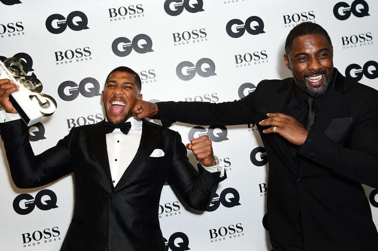 Review of the Year 2017: September: Anthony Joshua (left) with his Best Sportsman award poses with Idris Elba during the GQ Men of the Year Awards 2017 held at the Tate Modern, London. Review of the Year 2017: September: Anthony Joshua (left) with his Best Sportsman award poses with Idris Elba during the GQ Men of the Year Awards 2017 held at the Tate Modern, London.
