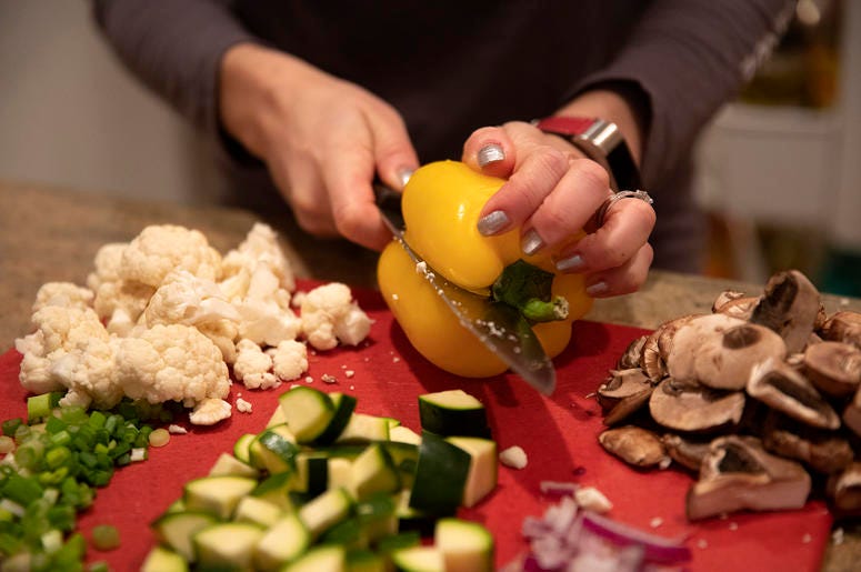 Penny Shack chops vegetables for a vegan vegetable and tofu stir fry for lunch on Tuesday, Jan. 8, 2019, at her home in Chicago, Ill. Penny Shack chops vegetables for a vegan vegetable and tofu stir fry for lunch on Tuesday, Jan. 8, 2019, at her home in Chicago, Ill.