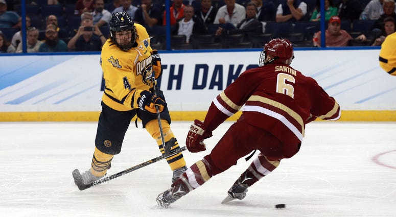 NCAA Hockey: Frozen Four-Quinnipiac vs Boston College Apr 7, 2016; Tampa, FL, USA; Quinnipiac Bobcats defenseman Connor Clifton (4) shoots as Boston College Eagles defenseman Steve Santini (6) attempts to defend during the second period of the semifinals of the 2016 Frozen Four college ice hockey tournament