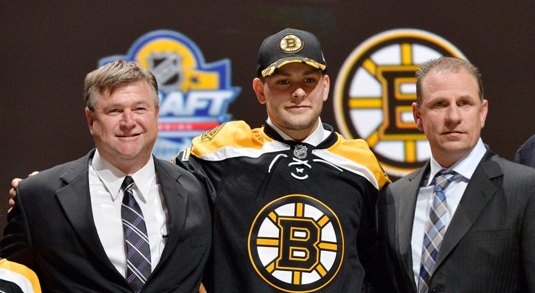 NHL: NHL Draft Jun 26, 2015; Sunrise, FL, USA; Jakub Zboril poses for a photo with team executives after being selected as the number thirteen overall pick to the Boston Bruins in the first round of the 2015 NHL Draft at BB&T Center. Mandatory Credit: Steve Mitchell-USA