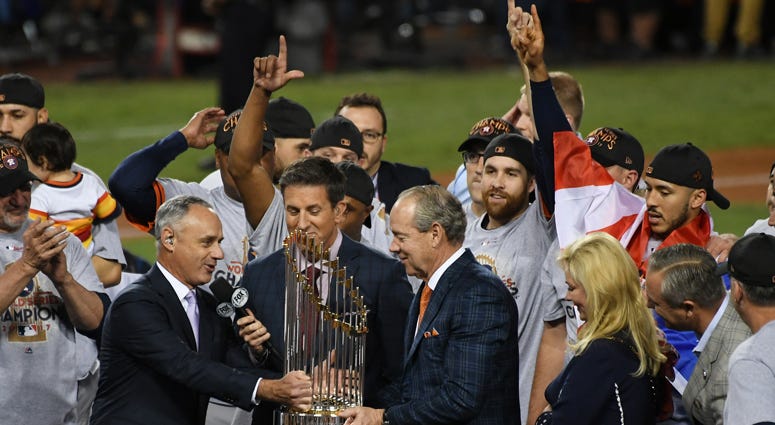 MLB commissioner Rob Manfred presents Astros owner Jim Crane with the Commissioner's Trophy after the Astros defeated the Dodgers in Game 7 to win the World Series on Nov. 1, 2017, at Dodger Stadium in Los Angeles. MLB commissioner Rob Manfred presents Astros owner Jim Crane with the Commissioner's Trophy after the Astros defeated the Dodgers in Game 7 to win the World Series on Nov. 1, 2017, at Dodger Stadium in Los Angeles.