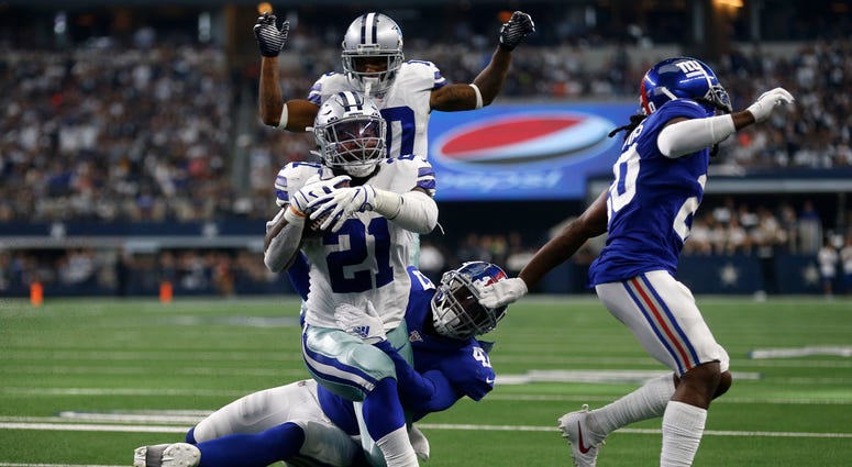 Dallas Cowboys running back Ezekiel Elliott (21) runs the ball for a touchdown after getting past New York Giants outside linebacker Alec Ogletree, center bottom, and Janoris Jenkins, right, as wide receiver Tavon Austin, rear, looks on in the second half Dallas Cowboys running back Ezekiel Elliott (21) runs the ball for a touchdown after getting past New York Giants outside linebacker Alec Ogletree, center bottom, and Janoris Jenkins, right, as wide receiver Tavon Austin, rear, looks on in the second half