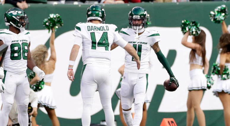 New York Jets quarterback Sam Darnold (14) celebrates a touchdown with Robby Anderson (11) during the first half of an NFL football game against the Dallas Cowboys, Sunday, Oct. 13, 2019, in East Rutherford, N.J. New York Jets quarterback Sam Darnold (14) celebrates a touchdown with Robby Anderson (11) during the first half of an NFL football game against the Dallas Cowboys, Sunday, Oct. 13, 2019, in East Rutherford, N.J.