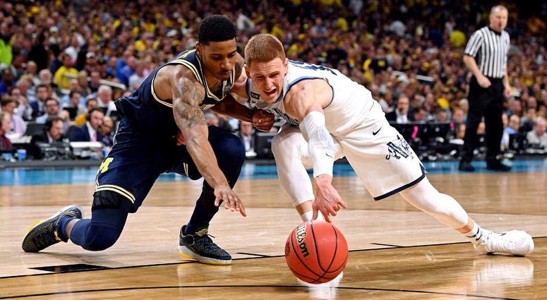 Michigan Wolverines guard Charles Matthews and Villanova Wildcats guard Donte DiVincenzo go for a loose ball during the national championship game on April 2, 2018, at the Alamodome in San Antonio. Michigan Wolverines guard Charles Matthews and Villanova Wildcats guard Donte DiVincenzo go for a loose ball during the national championship game on April 2, 2018, at the Alamodome in San Antonio.