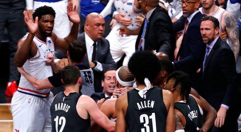 Nets coach Kenny Atkinson stops forward Jared Dudley from going after 76ers center Joel Embiid during the second half of a playoff game on April 20, 2019, at Barclays Center. Nets coach Kenny Atkinson stops forward Jared Dudley from going after 76ers center Joel Embiid during the second half of a playoff game on April 20, 2019, at Barclays Center.