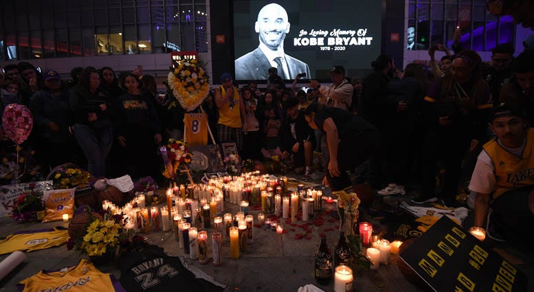 Fans gather at LA Live in Los Angeles to pay tribute to Kobe Bryant, who died earlier in a helicopter crash on Jan. 26, 2020. Fans gather at LA Live in Los Angeles to pay tribute to Kobe Bryant, who died earlier in a helicopter crash on Jan. 26, 2020.
