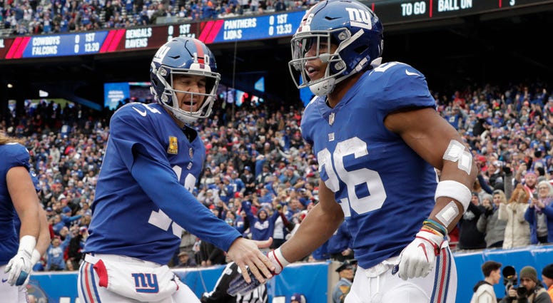 Nov 18, 2018; East Rutherford, NJ, USA; New York Giants running back Saquon Barkley (26) celebrates his touchdown with quarterback Eli Manning (10) during the first half at MetLife Stadium. Mandatory Credit: Vincent Carchietta-USA TODAY Sports Nov 18, 2018; East Rutherford, NJ, USA; New York Giants running back Saquon Barkley (26) celebrates his touchdown with quarterback Eli Manning (10) during the first half at MetLife Stadium. Mandatory Credit: Vincent Carchietta-USA TODAY Sports