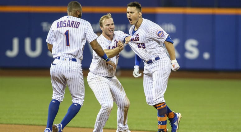 Amed Rosario, Pete Alonso, and J.D. Davis celebrate after another Mets win. Amed Rosario, Pete Alonso, and J.D. Davis celebrate after another Mets win.