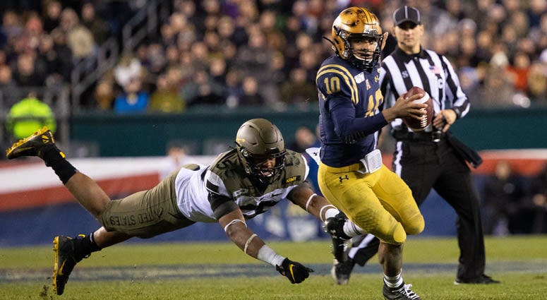 Navy quarterback Malcolm Perry runs with the ball past Army Black Knights defensive lineman Edriece Patterson on Dec. 14, 2019, at Lincoln Financial Field in Philadelphia. Navy quarterback Malcolm Perry runs with the ball past Army Black Knights defensive lineman Edriece Patterson on Dec. 14, 2019, at Lincoln Financial Field in Philadelphia.