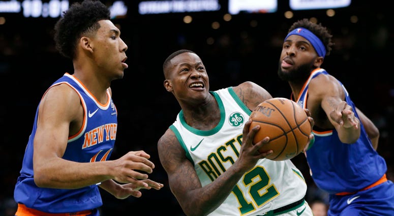 Dec 6, 2018; Boston, MA, USA; Boston Celtics guard Terry Rozier (12) is guarded by New York Knicks guard Allonzo Trier (14) and center Mitchell Robinson (26) during the second half at TD Garden. Mandatory Credit: Greg M. Cooper-USA TODAY Sports Dec 6, 2018; Boston, MA, USA; Boston Celtics guard Terry Rozier (12) is guarded by New York Knicks guard Allonzo Trier (14) and center Mitchell Robinson (26) during the second half at TD Garden. Mandatory Credit: Greg M. Cooper-USA TODAY Sports