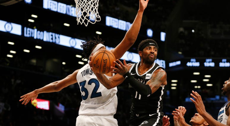Nets guard Kyrie Irving attempts a pass against Timberwolves center Karl-Anthony Towns Oct 23, 2019; Brooklyn, NY Nets guard Kyrie Irving attempts a pass against Timberwolves center Karl-Anthony Towns Oct 23, 2019; Brooklyn, NY