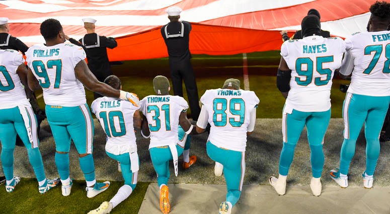 Miami Dolphins players kneel during the national anthem on Nov. 13, 2018, at Bank of America Stadium in Charlotte, North Carolina. Miami Dolphins players kneel during the national anthem on Nov. 13, 2018, at Bank of America Stadium in Charlotte, North Carolina.