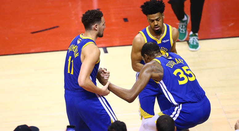 Kevin Durant (35) is helped to his feet by Klay Thompson (11) and Quinn Cook of the Golden State Warriors after sustaining an injury against the Raptors in Game 5 of the 2019 NBA Finals on June 10, 2019, at Scotiabank Arena in Toronto, Canada. Kevin Durant (35) is helped to his feet by Klay Thompson (11) and Quinn Cook of the Golden State Warriors after sustaining an injury against the Raptors in Game 5 of the 2019 NBA Finals on June 10, 2019, at Scotiabank Arena in Toronto, Canada.