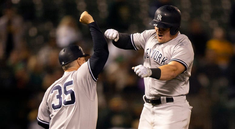 The Yankees' Luke Voit celebrates his solo home run with third-base coach Phil Nevin on Sept. 4, 2018, at Oakland Coliseum in Oakland, California. The Yankees' Luke Voit celebrates his solo home run with third-base coach Phil Nevin on Sept. 4, 2018, at Oakland Coliseum in Oakland, California.