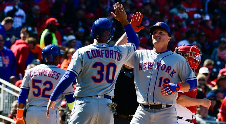 Mets right fielder Jay Bruce (19) high-fives Michael Conforto after hitting a grand slam against the Washington Nationals on April 5, 2018, at Nationals Park in Washington, D.C. Mets right fielder Jay Bruce (19) high-fives Michael Conforto after hitting a grand slam against the Washington Nationals on April 5, 2018, at Nationals Park in Washington, D.C.