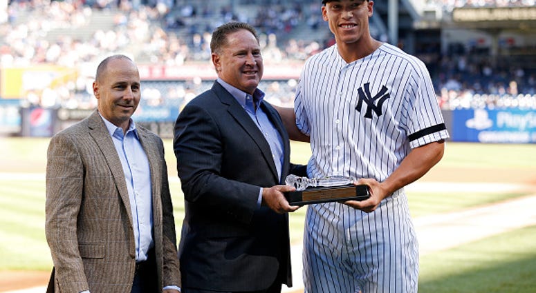 Damon Oppenheimer with Brian Cashman and Aaron Judge.