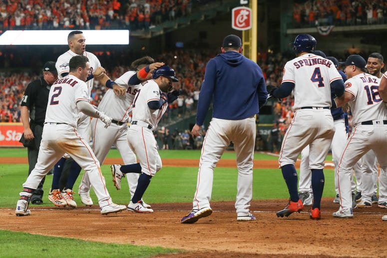 Jose Altuve of the Houston Astros comes home to score after his walk-off two-run home run to win game six of the American League Championship Series 6-4 against the Yankees at Minute Maid Park on October 19, 2019 in Houston, Texas.