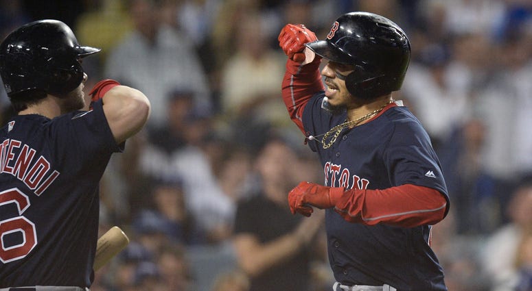 Red Sox outfielder Mookie Betts celebrates with teammate Andrew Benintendi after hitting a solo home run in the sixth inning against the Dodgers in Game 5 of the 2018 World Series at Dodger Stadium in Los Angeles. Red Sox outfielder Mookie Betts celebrates with teammate Andrew Benintendi after hitting a solo home run in the sixth inning against the Dodgers in Game 5 of the 2018 World Series at Dodger Stadium in Los Angeles.