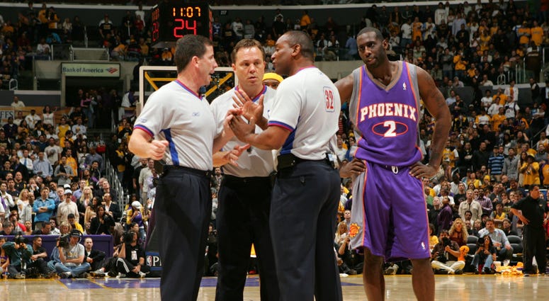 Los Angeles, CA - April 28, 2006: Tim Thomas of the Phoenix Suns looks in on as referees Tim Donaghy #21, Bill Spooner #22 and Eddie F. Rush discuss the proper call Los Angeles, CA - April 28, 2006: Tim Thomas of the Phoenix Suns looks in on as referees Tim Donaghy #21, Bill Spooner #22 and Eddie F. Rush discuss the proper call