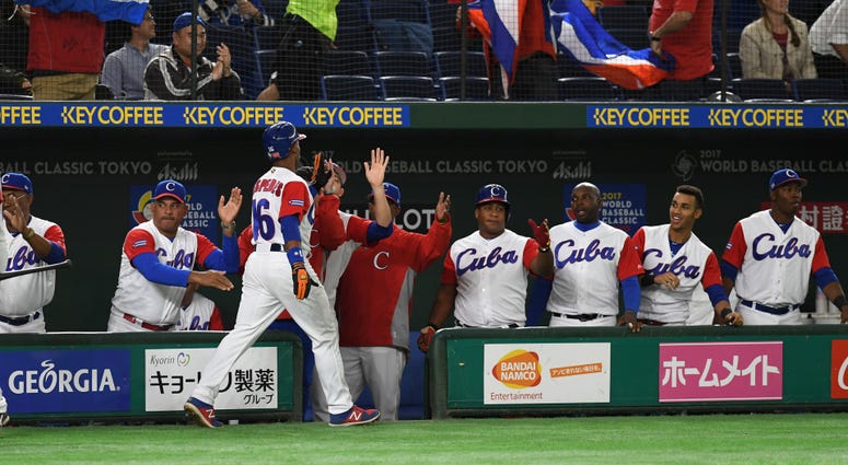 Outfielder Yoelkis Cespedes #16 of Cuba high fives with his teammates after scoring a run in the 2017 World Baseball Classic Tokyo, Japan – Mar. 8 Outfielder Yoelkis Cespedes #16 of Cuba high fives with his teammates after scoring a run in the 2017 World Baseball Classic Tokyo, Japan – Mar. 8