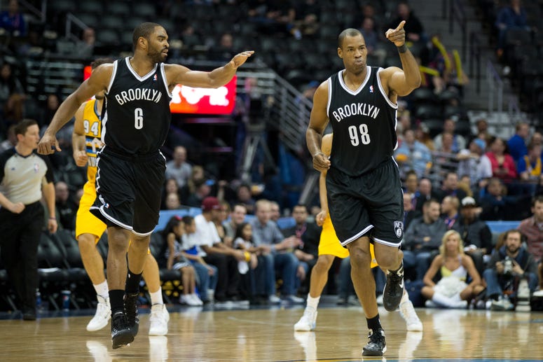 Jason Collins of the Nets celebrates after making a basket with teammate Alan Anderson #6 during a game against the Denver Nuggets at Pepsi Center on February 27, 2014 in Denver, Colorado. Jason Collins of the Nets celebrates after making a basket with teammate Alan Anderson #6 during a game against the Denver Nuggets at Pepsi Center on February 27, 2014 in Denver, Colorado.