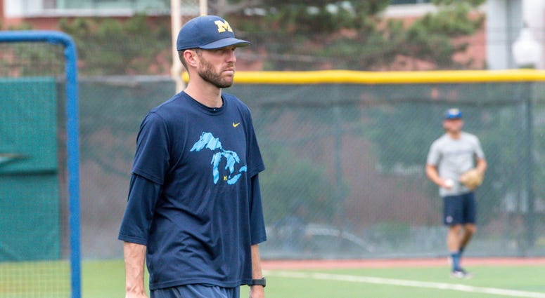 Michigan Wolverines pitching coach Chris Fetter looks on during team practice Jun 20, 2019; Omaha, NE Michigan Wolverines pitching coach Chris Fetter looks on during team practice Jun 20, 2019; Omaha, NE