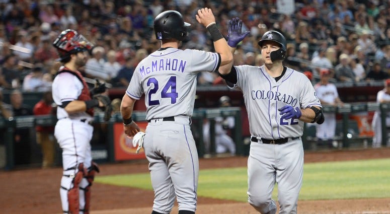 Colorado Rockies pinch hitter Chris Iannetta (22) slaps hands with Colorado Rockies second baseman Ryan McMahon (24) after hitting a two-run home run against the Arizona Diamondbacks during the eighth inning on Jul 7, 2019 at Chase Field. Colorado Rockies pinch hitter Chris Iannetta (22) slaps hands with Colorado Rockies second baseman Ryan McMahon (24) after hitting a two-run home run against the Arizona Diamondbacks during the eighth inning on Jul 7, 2019 at Chase Field.