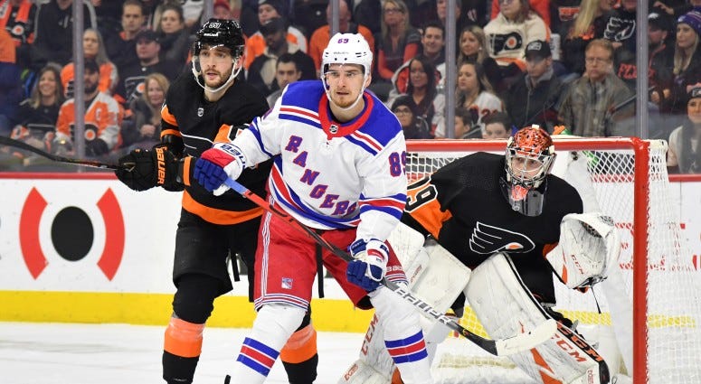 New York Rangers right wing Pavel Buchnevich (89) with Philadelphia Flyers defenseman Shayne Gostisbehere (53) in front of goaltender Carter Hart (79) during the first period on Dec 23, 2019 at Wells Fargo Center. New York Rangers right wing Pavel Buchnevich (89) with Philadelphia Flyers defenseman Shayne Gostisbehere (53) in front of goaltender Carter Hart (79) during the first period on Dec 23, 2019 at Wells Fargo Center.