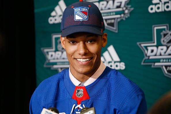 Rangers prospect K'Andre Miller speaks with reporters.