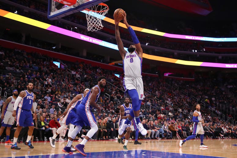 Andre Drummond of the Detroit Pistons gets to the basket next to Joel Embiid #21 of the Philadelphia 76ers during the first half at Little Caesars Arena on December 23, 2019 in Detroit, Michigan. Andre Drummond of the Detroit Pistons gets to the basket next to Joel Embiid #21 of the Philadelphia 76ers during the first half at Little Caesars Arena on December 23, 2019 in Detroit, Michigan.