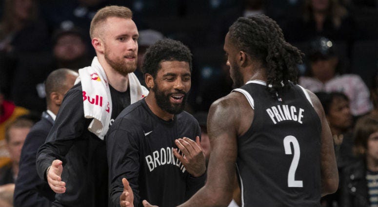 Brooklyn Nets guard Dzanan Musa, left, and /guard Kyrie Irving, center, greet forward Taurean Prince (2) as he comes into the bench during a timeout in the first half of an exhibition NBA basketball game against the Sesi/Franca Basketball Club, Friday, Oc Brooklyn Nets guard Dzanan Musa, left, and /guard Kyrie Irving, center, greet forward Taurean Prince (2) as he comes into the bench during a timeout in the first half of an exhibition NBA basketball game against the Sesi/Franca Basketball Club, Friday, Oc