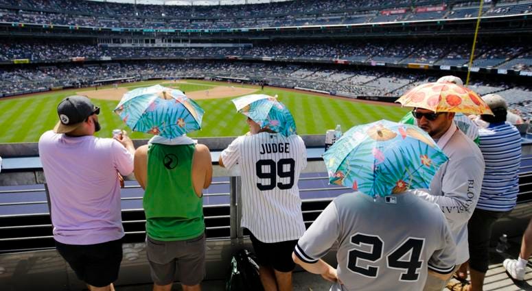Fans use umbrella hats to protect themselves from the sun during the sixth inning of a baseball game between the New York Yankees and the Colorado Rockies Saturday, July 20, 2019, in New York. Fans use umbrella hats to protect themselves from the sun during the sixth inning of a baseball game between the New York Yankees and the Colorado Rockies Saturday, July 20, 2019, in New York.