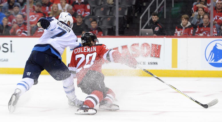 Oct 4, 2019; Newark, NJ, USA; New Jersey Devils center Blake Coleman (20) scores a goal while being checked by Winnipeg Jets defenseman Dmitry Kulikov (7) during the second period at Prudential Center. Oct 4, 2019; Newark, NJ, USA; New Jersey Devils center Blake Coleman (20) scores a goal while being checked by Winnipeg Jets defenseman Dmitry Kulikov (7) during the second period at Prudential Center.