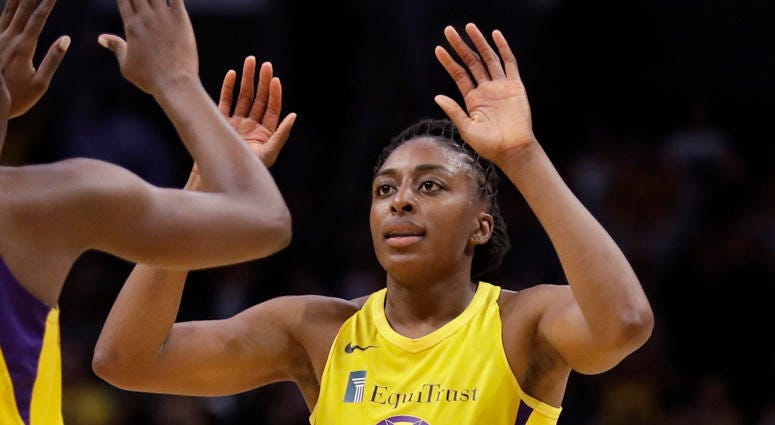 In this May 31, 2019, file photo, the Los Angeles Sparks' Chiney Ogwumike, obscured at left, and her sister Nneka Ogwumike celebrate after a win over the Connecticut Sun in Los Angeles. In this May 31, 2019, file photo, the Los Angeles Sparks' Chiney Ogwumike, obscured at left, and her sister Nneka Ogwumike celebrate after a win over the Connecticut Sun in Los Angeles.