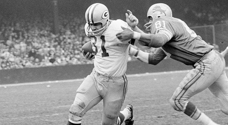 In this Nov. 22, 1962, file photo, Green Bay Packers fullback Jim Taylor (31) is brought down by Detroit Lions' Dick Lane in the third quarter of an NFL football game in Detroit. In this Nov. 22, 1962, file photo, Green Bay Packers fullback Jim Taylor (31) is brought down by Detroit Lions' Dick Lane in the third quarter of an NFL football game in Detroit.