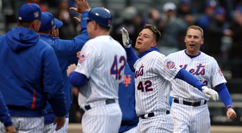 The Mets' Wilmer Flores celebrates with teammates after hitting a walk-off solo home run to beat the Milwaukee Brewers on April 15, 2018, at Citi Field. The Mets' Wilmer Flores celebrates with teammates after hitting a walk-off solo home run to beat the Milwaukee Brewers on April 15, 2018, at Citi Field.