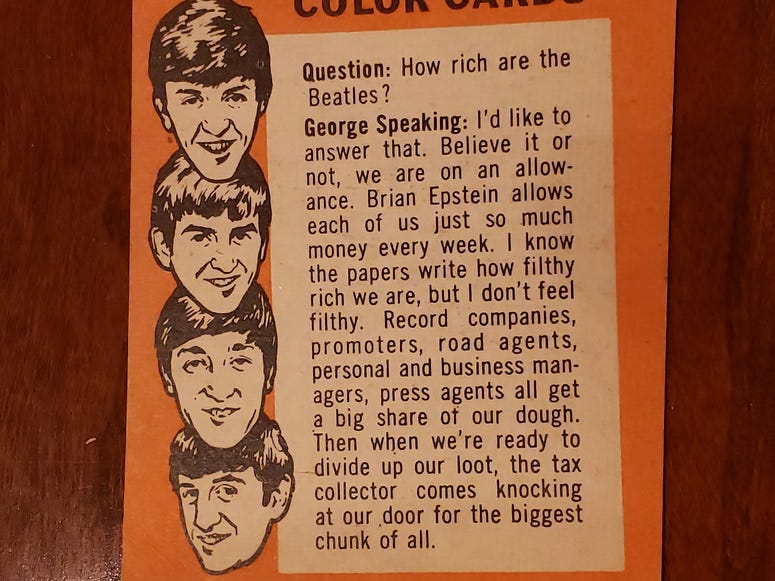 George Harrison takes a question on the back of this Beatles card. George Harrison takes a question on the back of this Beatles card.
