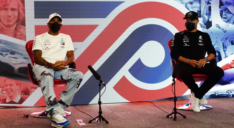 Lewis Hamilton of Great Britain and Valtteri Bottas of Finland and Mercedes GP talk in the Drivers Press Conference during previews ahead of the F1 Grand Prix of Great Britain at Silverstone on Thursday, July 30, 2020 in Silverstone, England.