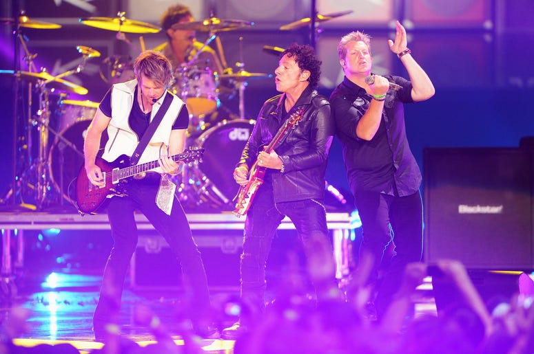 Members Of Journey On Stage Singing